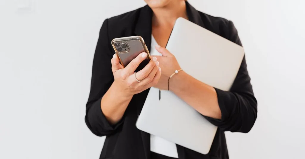 Professional woman holding smartphone and tablet, demonstrating LLM data analysis tools for business intelligence.