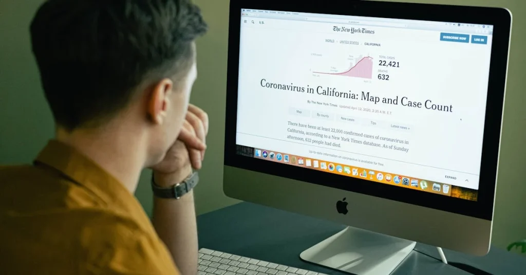 Person reading coronavirus data analysis article on computer monitor showing case counts and map visualization.